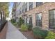 Street view of modern townhomes with brick facade and manicured landscaping along the sidewalk at 1800 Morning Glory Ne Ln, Atlanta, GA 30324