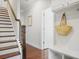 Hallway with stairs, hardwood floors, and custom built-in storage with seating area at 1800 Morning Glory Ne Ln, Atlanta, GA 30324