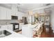 Open kitchen design with stainless appliances, island seating, and a view into the dining and living area at 1800 Morning Glory Ne Ln, Atlanta, GA 30324