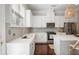 Bright kitchen features white cabinets, stainless steel appliances, and a stylish woven pendant light at 1800 Morning Glory Ne Ln, Atlanta, GA 30324