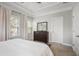 Light-filled main bedroom featuring a large window, dresser, and neutral decor at 1800 Morning Glory Ne Ln, Atlanta, GA 30324