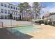 Community pool with plenty of room for chairs and tables and an apartment building in the background at 1800 Morning Glory Ne Ln, Atlanta, GA 30324