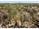 Aerial shot of a neighborhood surrounded by lush trees with mountain view in the distance at 1135 Banbury Cross, Avondale Estates, GA 30002