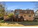 View of the home's backyard featuring a deck, lawn, and fenced-in area on a sunny day at 1135 Banbury Cross, Avondale Estates, GA 30002