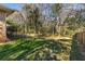 Great backyard view of the lawn bordered by a chain link fence with mature trees at 1135 Banbury Cross, Avondale Estates, GA 30002