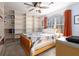 Bright bedroom with built-in bookshelves, ceiling fan, and cozy quilt at 1135 Banbury Cross, Avondale Estates, GA 30002