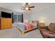 This bedroom features a ceiling fan, plush carpeting, and a bed with a colorful comforter at 1135 Banbury Cross, Avondale Estates, GA 30002