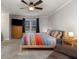 This bedroom features a ceiling fan, plush carpeting, and a bed with a colorful comforter at 1135 Banbury Cross, Avondale Estates, GA 30002
