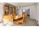 Dining room features a wooden table with seating for six, a glass cabinet, and a modern chandelier at 1135 Banbury Cross, Avondale Estates, GA 30002