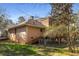 Back exterior view of the home with a deck and grassy lawn on a sunny day at 1135 Banbury Cross, Avondale Estates, GA 30002