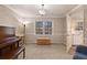 Bright living room with a piano, a window with natural light, and an adjacent eat-in kitchen at 1135 Banbury Cross, Avondale Estates, GA 30002