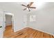 Cozy bedroom featuring hardwood floors, a ceiling fan, and natural light through a window at 817 N Evelyn Nw, Atlanta, GA 30318