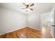 An empty bedroom featuring hardwood floors, a ceiling fan, and a window with natural light at 817 N Evelyn Nw, Atlanta, GA 30318