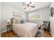 Cozy bedroom with ceiling fan, wood floors, natural light, and neutral decor at 817 N Evelyn Nw, Atlanta, GA 30318