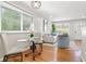 Open dining area with hardwood floors, a glass table, and views into the living room at 817 N Evelyn Nw, Atlanta, GA 30318