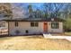 Charming single-story home with a freshly painted exterior, orange front door, and well-manicured lawn at 817 N Evelyn Nw, Atlanta, GA 30318