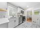 Modern kitchen with white subway tile backsplash, marble floors, and stainless steel appliances at 817 N Evelyn Nw, Atlanta, GA 30318