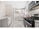 Modern kitchen with white cabinets, stainless steel appliances, and marble-patterned tile floors at 817 N Evelyn Nw, Atlanta, GA 30318