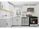 Kitchen with stainless steel appliances, marble floors, white cabinetry and a large window at 817 N Evelyn Nw, Atlanta, GA 30318