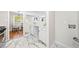 Kitchen with marble floors, stainless steel appliances, view of dining room and laundry hookups at 817 N Evelyn Nw, Atlanta, GA 30318