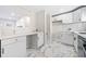 Open kitchen with marble floors, white cabinets, stainless steel appliances, and eat-in counter at 817 N Evelyn Nw, Atlanta, GA 30318