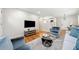 Open-concept living area with hardwood floors, modern decor, and a view into the kitchen at 817 N Evelyn Nw, Atlanta, GA 30318