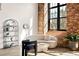 Cozy living area with exposed brick wall, large window, and stylish decor at 170 Boulevard Se # H213, Atlanta, GA 30312