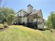 Beautiful backyard showcasing a covered porch and an expansive green lawn, perfect for outdoor activities at 5210 Timber S Trl, Sandy Springs, GA 30342