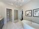 Bright bathroom featuring a soaking tub, glass shower, double vanities, and modern fixtures at 5210 Timber S Trl, Sandy Springs, GA 30342