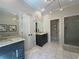 Bright bathroom featuring marble floors, dual vanities, and a glass enclosed shower at 5210 Timber S Trl, Sandy Springs, GA 30342