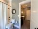 Bathroom featuring a shower with tub, toilet, vanity, and decorative round mirror at 5210 Timber S Trl, Sandy Springs, GA 30342