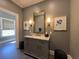 Stylish bathroom with a marble countertop vanity, elegant sconces, and decorative artwork for a luxurious feel at 5210 Timber S Trl, Sandy Springs, GA 30342