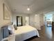 Comfortable bedroom with hardwood flooring, stylish lighting, and neutral color palette at 5210 Timber S Trl, Sandy Springs, GA 30342