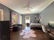 Cozy bedroom with stylish fan, decor, comfortable bed, rug and a seating area at 5210 Timber S Trl, Sandy Springs, GA 30342