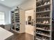 Large closet features shoe shelving, an island, and racks with lots of storage space at 5210 Timber S Trl, Sandy Springs, GA 30342