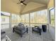 Covered patio with stone flooring and comfortable seating area overlooking wooded backyard at 5210 Timber S Trl, Sandy Springs, GA 30342