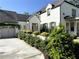 Stately white brick home featuring lush landscaping, a two-car garage, and traditional architectural details at 5210 Timber S Trl, Sandy Springs, GA 30342