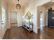 Inviting foyer featuring stylish lighting, console table, decorative mirror, and hardwood floors at 5210 Timber S Trl, Sandy Springs, GA 30342