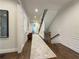 Bright hallway with hardwood floors, staircase and paneled walls leading to other rooms at 5210 Timber S Trl, Sandy Springs, GA 30342