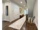 Long hallway with hardwood floors, white wainscoting, and decorative artwork on the walls at 5210 Timber S Trl, Sandy Springs, GA 30342