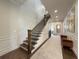 Hallway with staircase, wainscoting, rug runner and bench at 5210 Timber S Trl, Sandy Springs, GA 30342