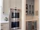 Modern kitchen with stainless steel double ovens and wine storage at 5210 Timber S Trl, Sandy Springs, GA 30342