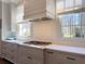 Modern kitchen with stainless steel appliances, light gray cabinets, and bright windows at 5210 Timber S Trl, Sandy Springs, GA 30342