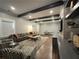 Comfortable living room offers dark wood beams, a plush sofa, built-in cabinets, and table tennis at 5210 Timber S Trl, Sandy Springs, GA 30342