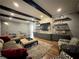Comfortable living room with beamed ceiling, built-in cabinets, shelving, and a cozy seating area at 5210 Timber S Trl, Sandy Springs, GA 30342