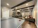 Open living area with a large sectional sofa, tv, built-in shelving and ping pong table at 5210 Timber S Trl, Sandy Springs, GA 30342