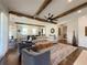 Open-concept living room featuring wood beams, hardwood floors, and views into the kitchen at 5210 Timber S Trl, Sandy Springs, GA 30342