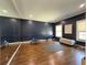 Bright exercise room with navy walls, wood floors, large mirror, and fitness equipment at 5210 Timber S Trl, Sandy Springs, GA 30342