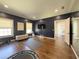 This well-lit workout room boasts navy trim and walls, wood floors, and exercise equipment at 5210 Timber S Trl, Sandy Springs, GA 30342
