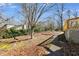 A spacious backyard features a path and some mature trees at 9760 Greenside Way, Douglasville, GA 30135